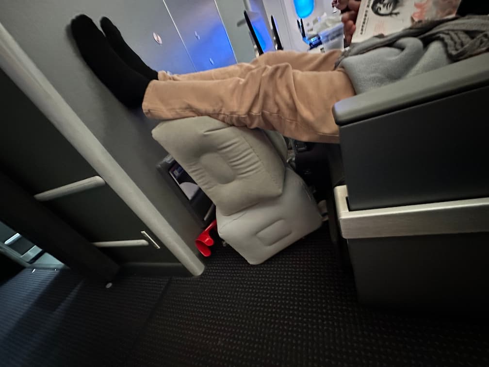 Leg elevated above heart level on a wedge elevation pillow to reduce swelling after ACL surgery