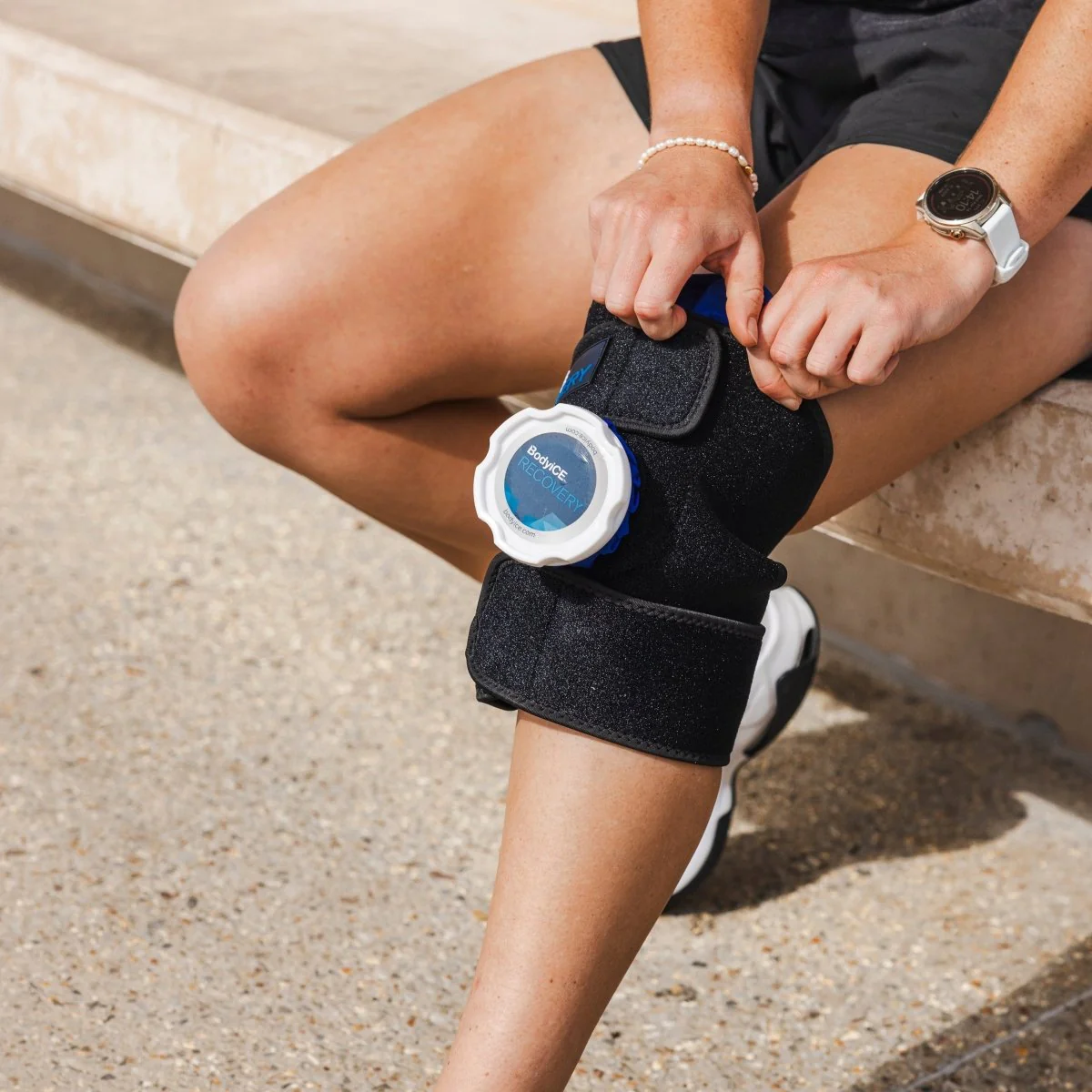 Fabric ice bag with straps designed to wrap tightly around the knee